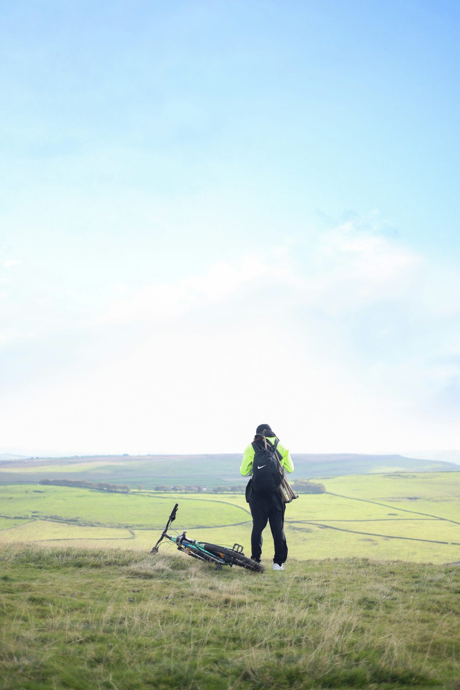 A man standing on top of a lush green field