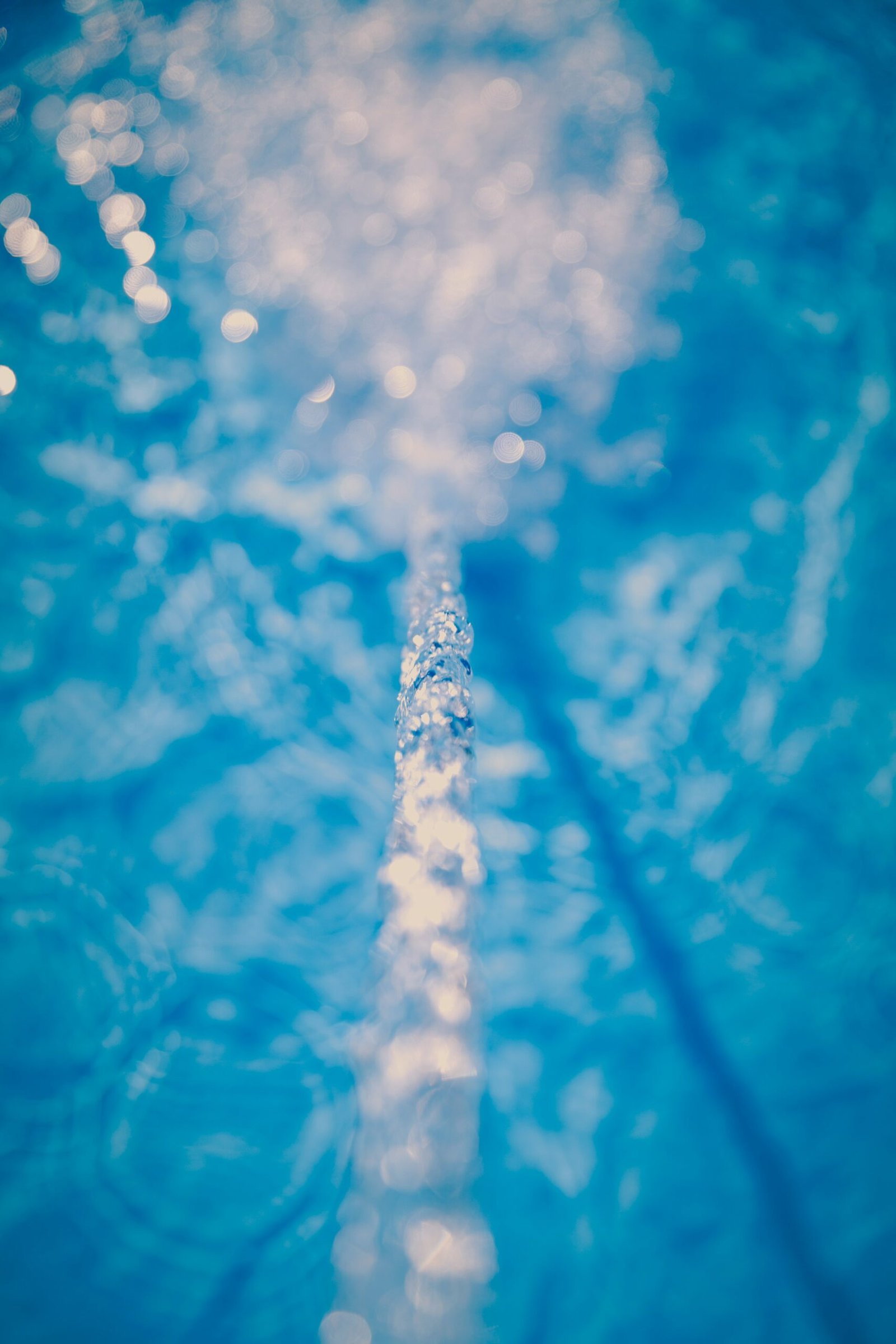 a pipe in the middle of a blue pool